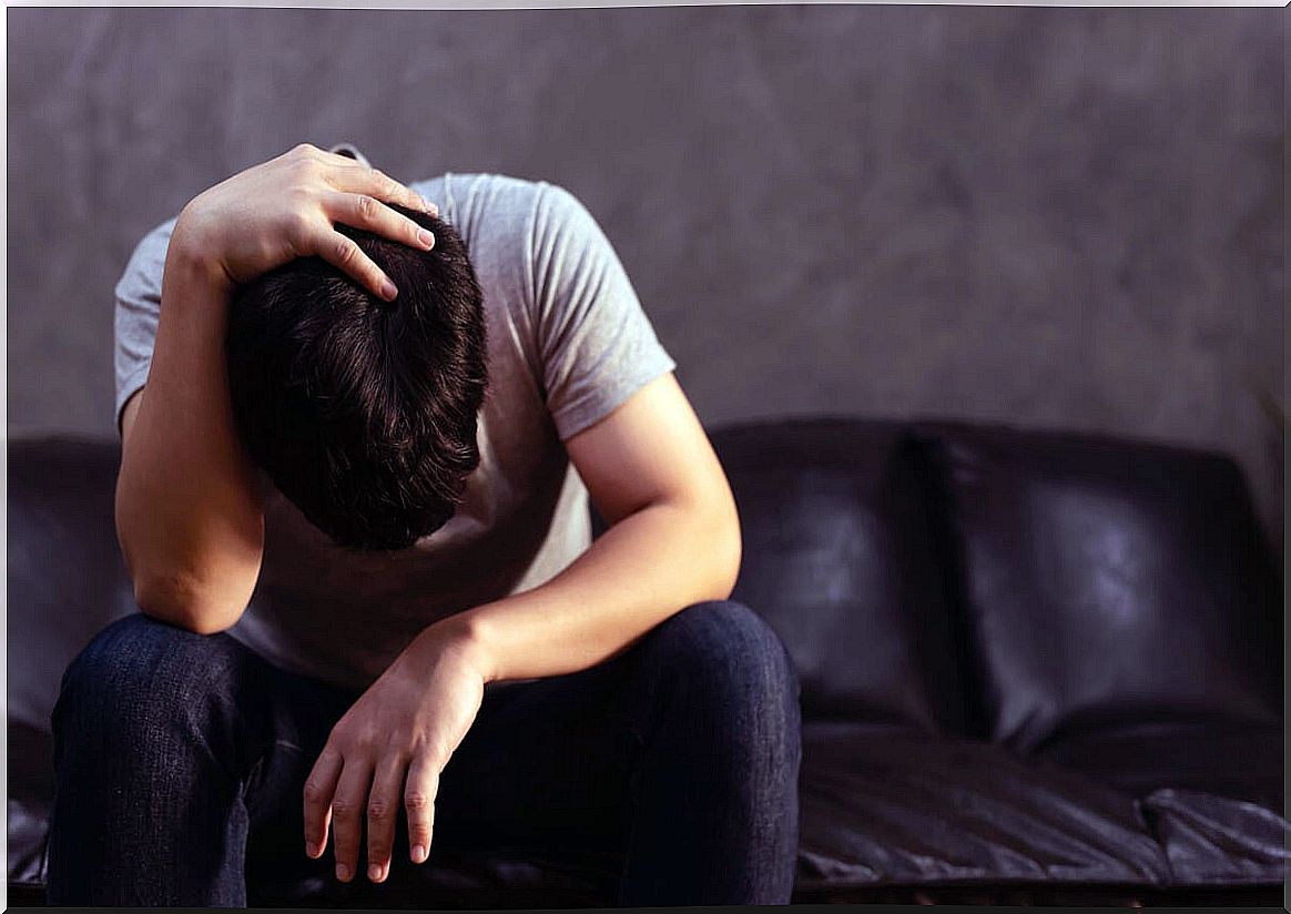 Man on sofa suffering from anxiety and sedentary lifestyle