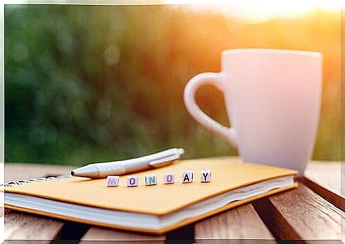 Cup of coffee next to notebook