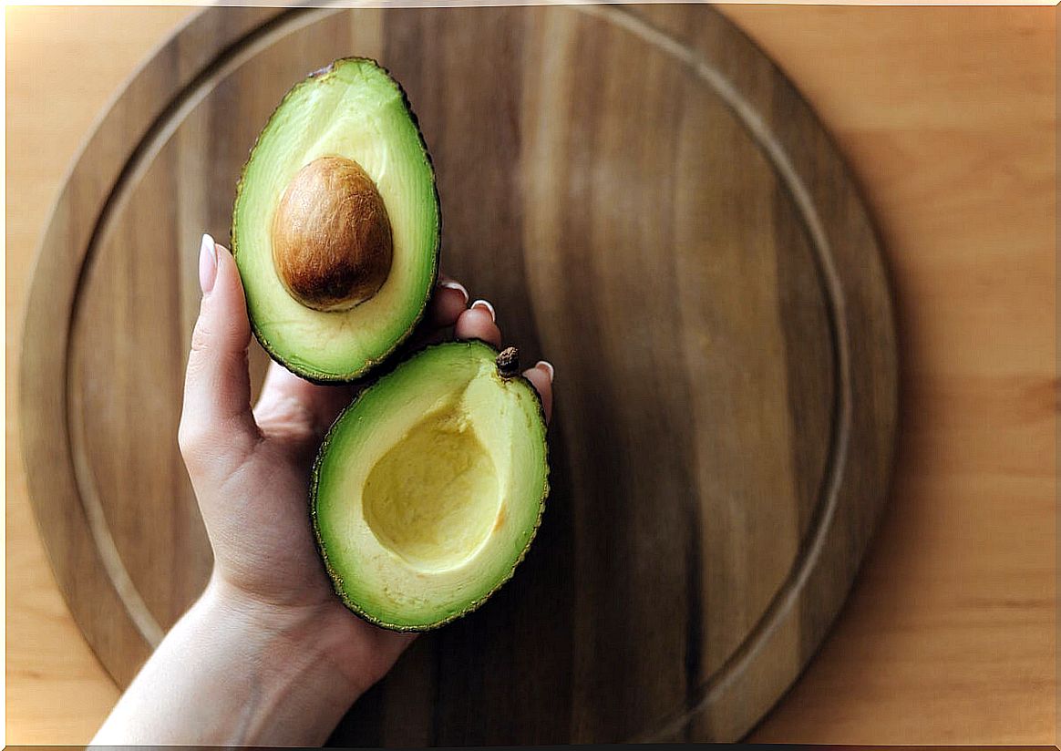 Woman with avocado in hand