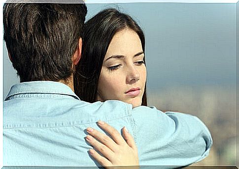 Woman hugging her partner thinking about another man