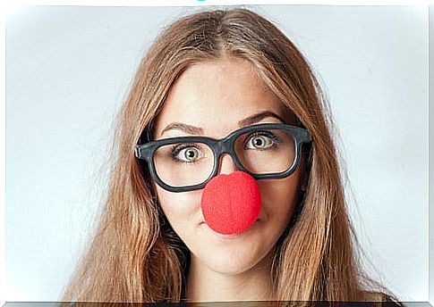 Woman with glasses and clown nose