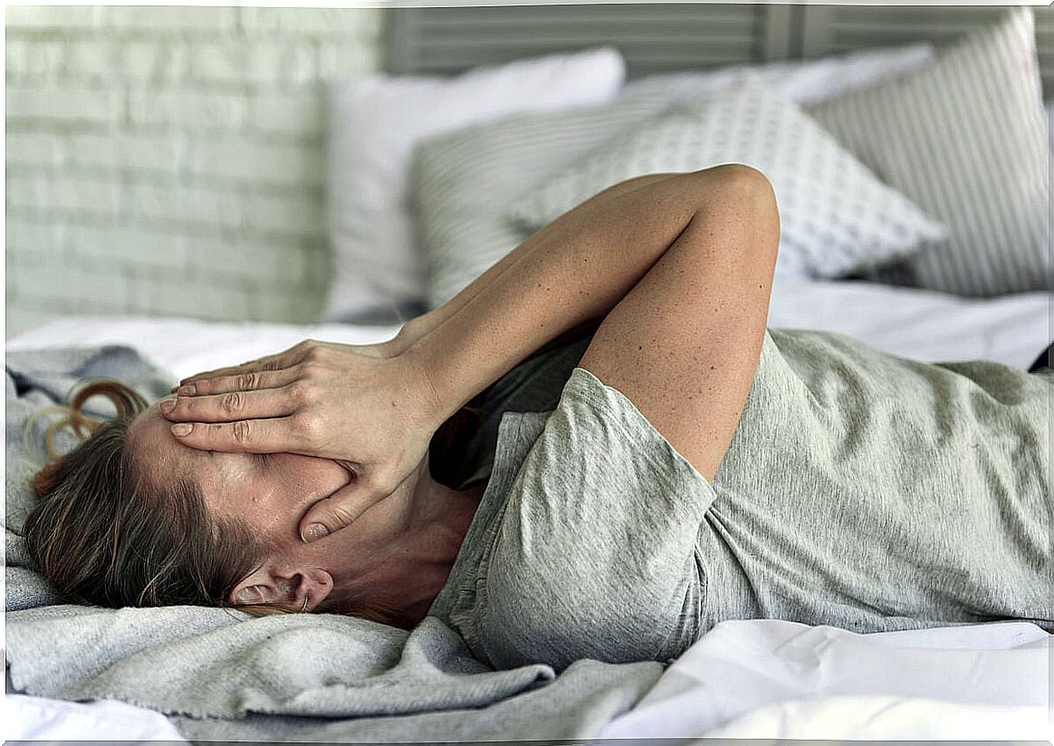 Anxious woman in bed feeling intense emotions 