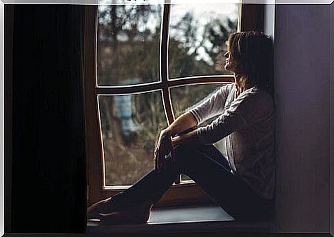 Woman in a window thinking about when everything does not matter to us