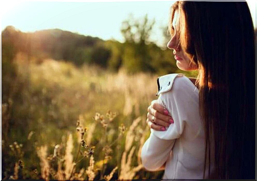 Woman hugging herself