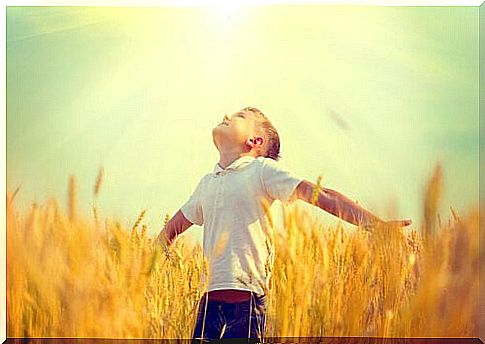 Boy with open arms showing hope