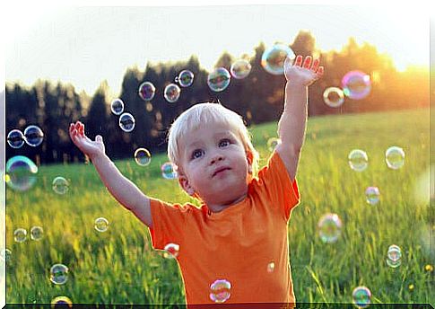 Boy playing with soap bubbles