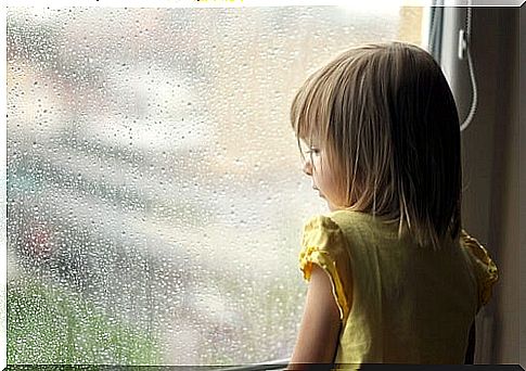 Little girl looking out the window