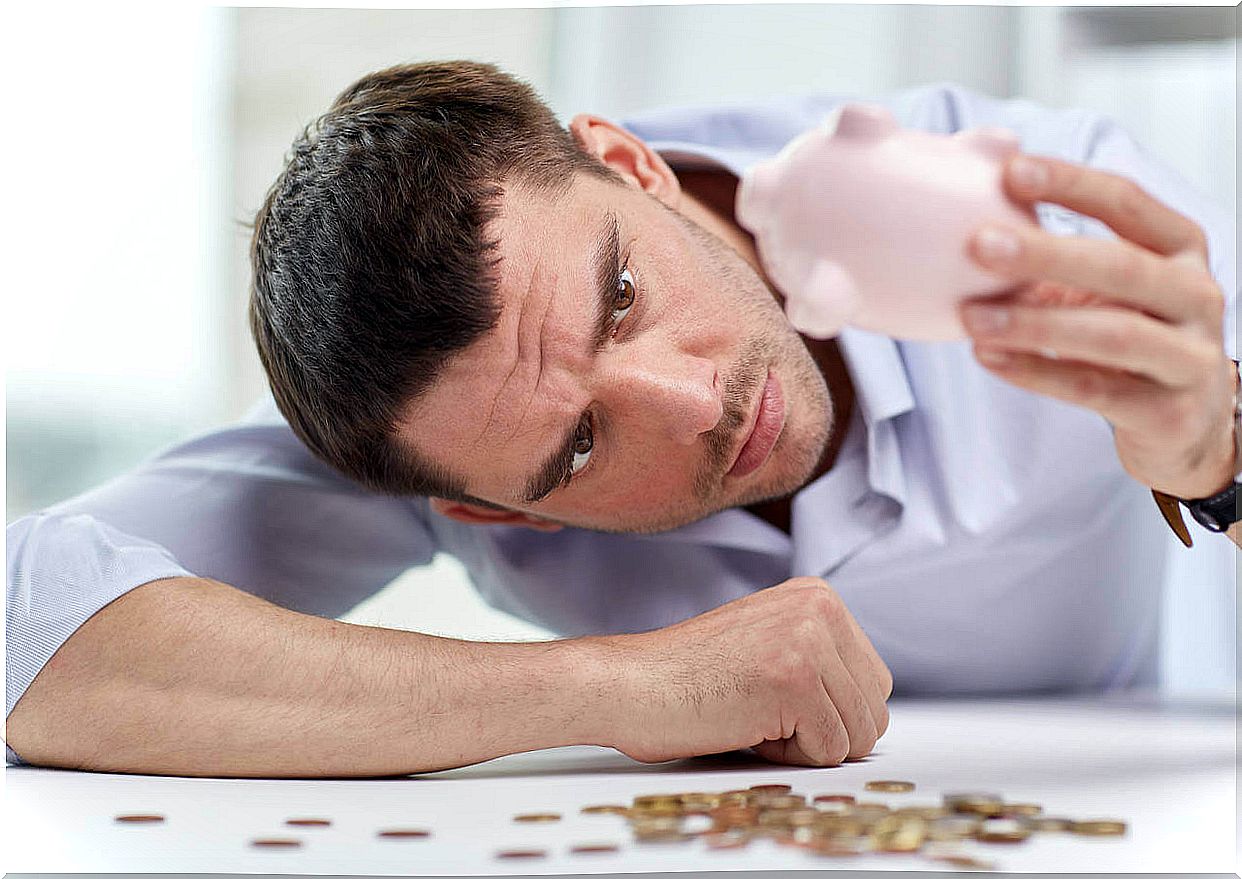 man with piggy bank symbolizing balance syndrome in red