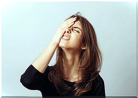 Woman with her hand on her head for her forgetfulness