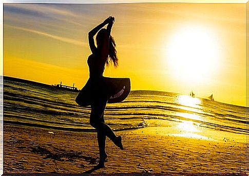 Woman dancing on the beach