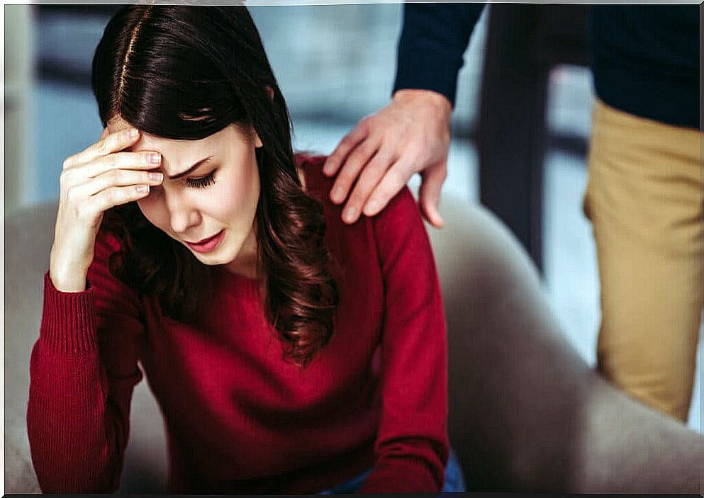 Worried woman with hand on head